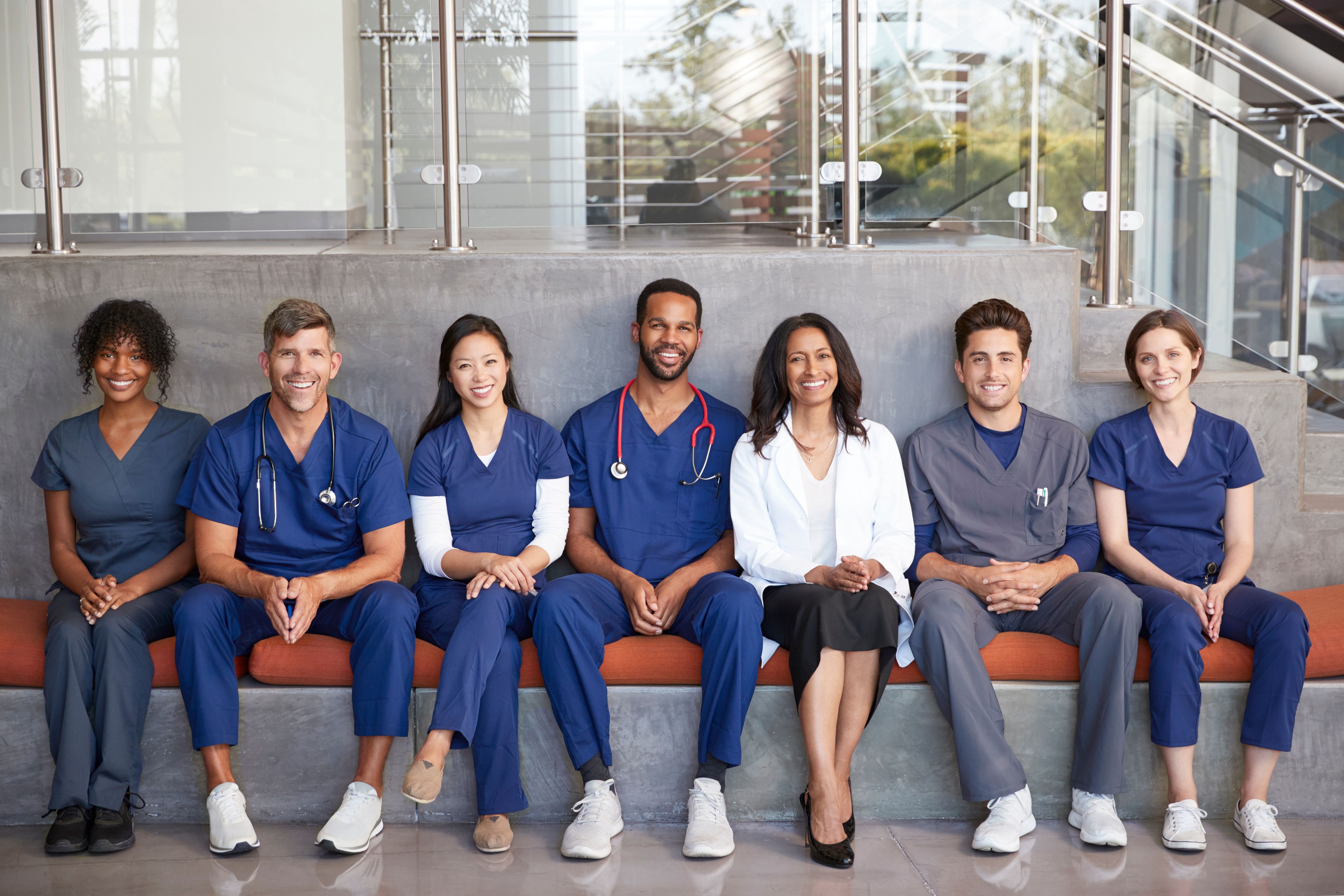 A diverse healthcare leadership team standing together